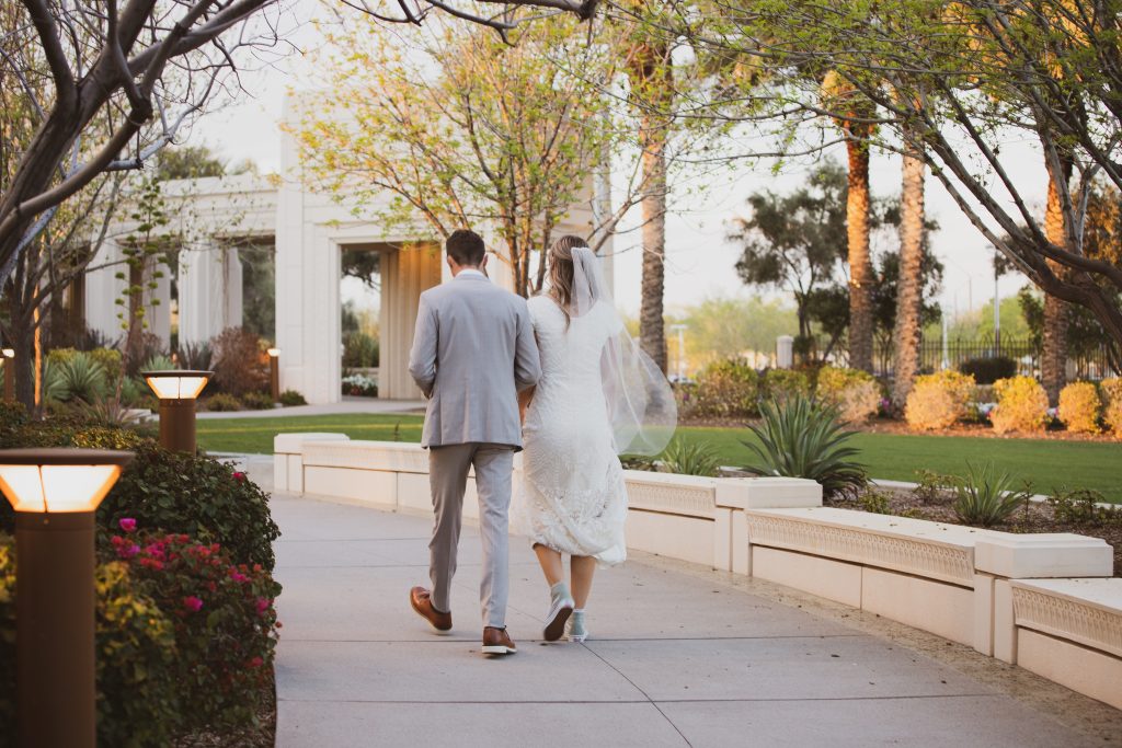 Bride and groom walking photo at the Gilbert Arizona Temple