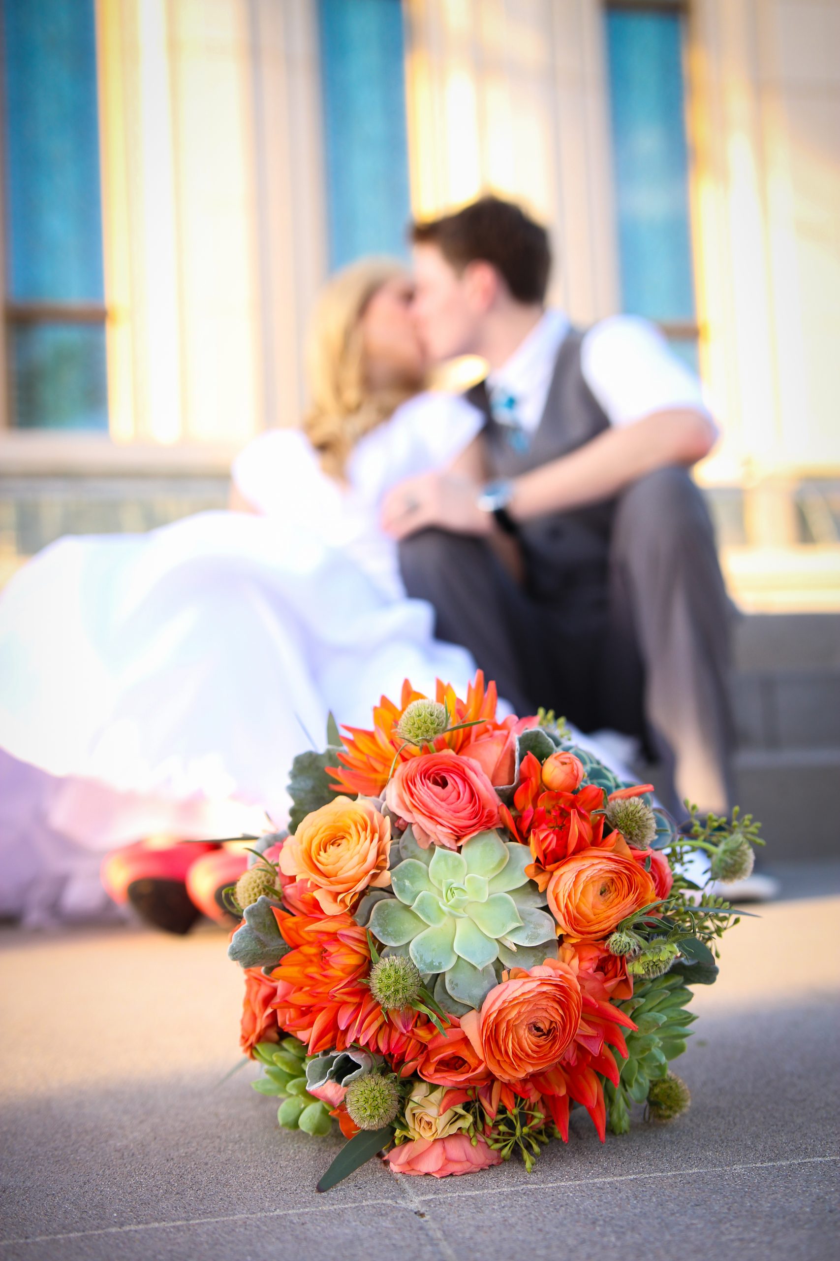 Bride and Groom at Gilbert Temple with wedding flowers