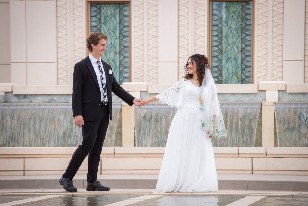 Bride leading groom bridal portrait at the Gilbert Temple