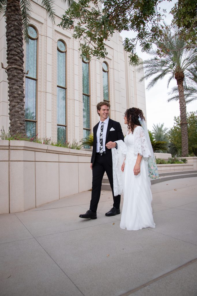 Groom and bride walking at the Gilbert Temple
