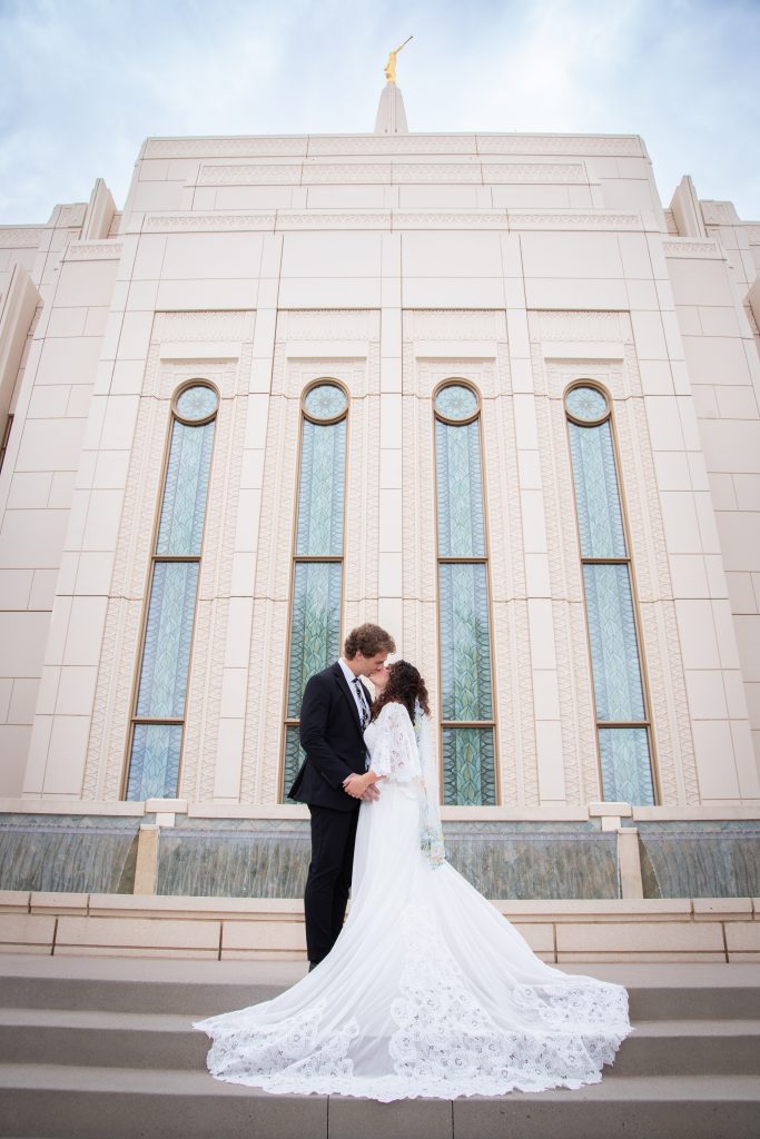 Bride and groom kissing on the steps at the Gilbert Arizona Temple
